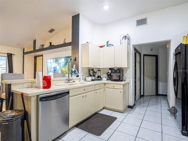 kitchen with black refrigerator, stainless steel dishwasher, sink, and a wealth of natural light