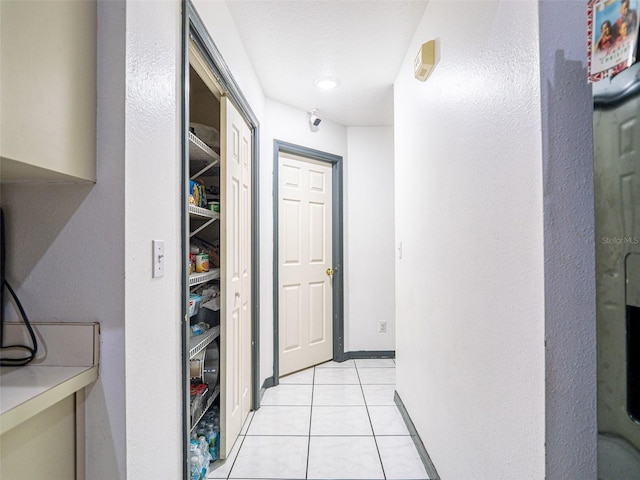 hallway featuring light tile patterned floors