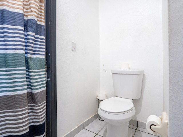 bathroom with toilet and tile patterned floors