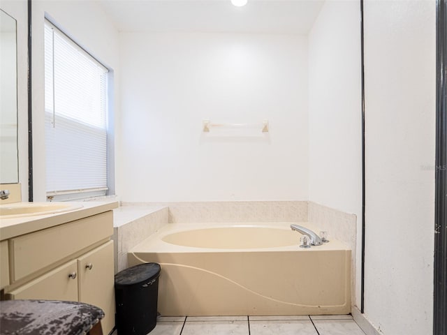 bathroom featuring vanity, tile patterned floors, and a bath