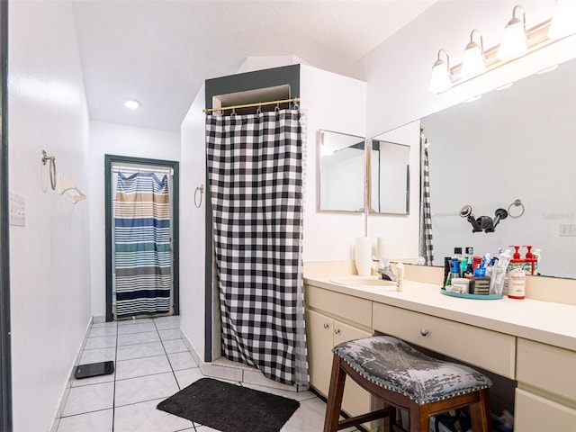 bathroom featuring vanity, curtained shower, and tile patterned flooring