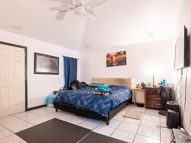 bedroom with lofted ceiling, light tile patterned floors, and ceiling fan