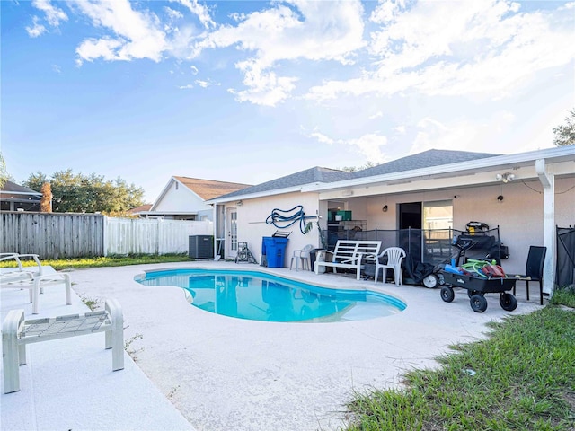 view of swimming pool featuring a patio and central AC