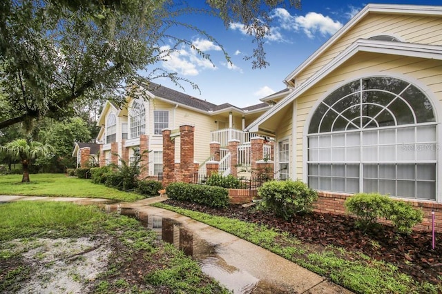 view of property exterior with a lawn