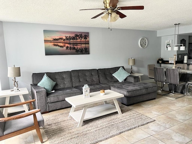 living room with light tile patterned floors, a textured ceiling, and ceiling fan