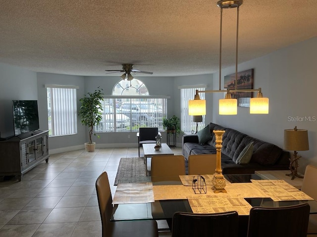 dining room featuring a textured ceiling, ceiling fan, and light tile patterned flooring