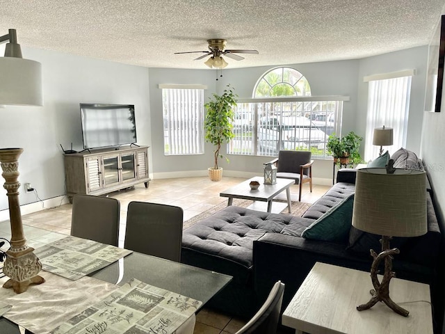 living room with ceiling fan and light tile patterned flooring