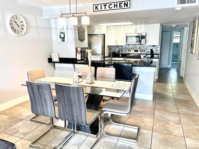 dining space featuring light tile patterned flooring