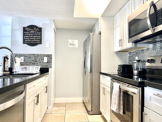 kitchen featuring backsplash, sink, white cabinets, and appliances with stainless steel finishes