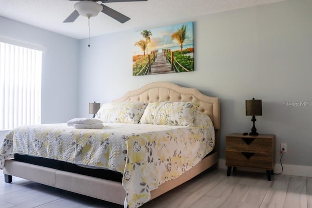 bedroom with hardwood / wood-style floors and ceiling fan