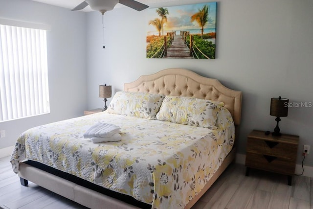 bedroom with hardwood / wood-style flooring and ceiling fan