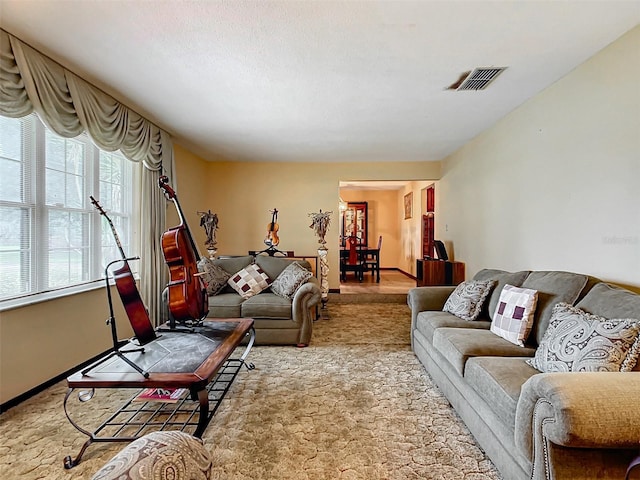 carpeted living room with a textured ceiling