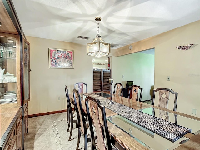 dining space featuring a notable chandelier