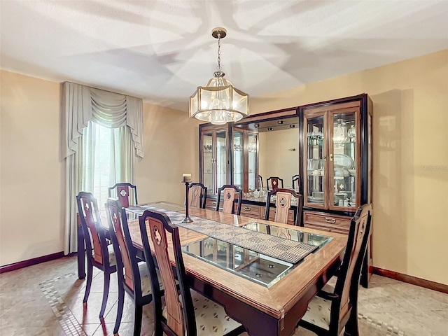 dining space with a notable chandelier and light tile patterned flooring