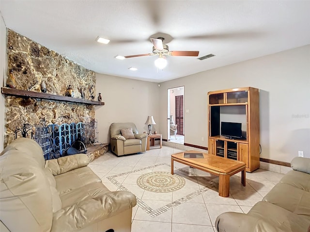 living room with a fireplace, ceiling fan, and light tile patterned flooring