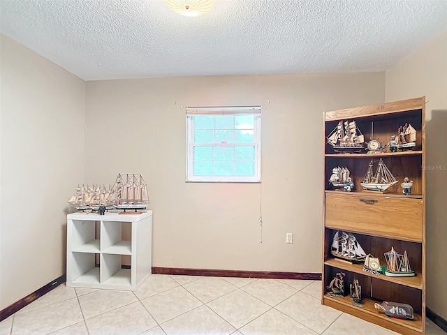 interior space featuring tile patterned flooring and a textured ceiling