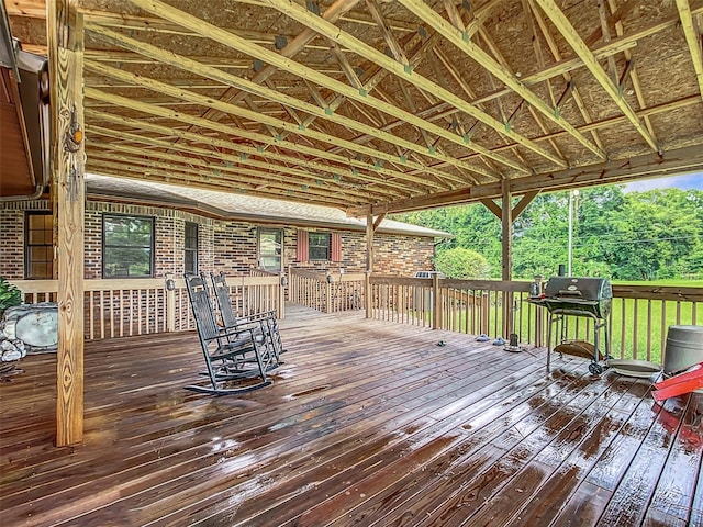 wooden terrace featuring a grill