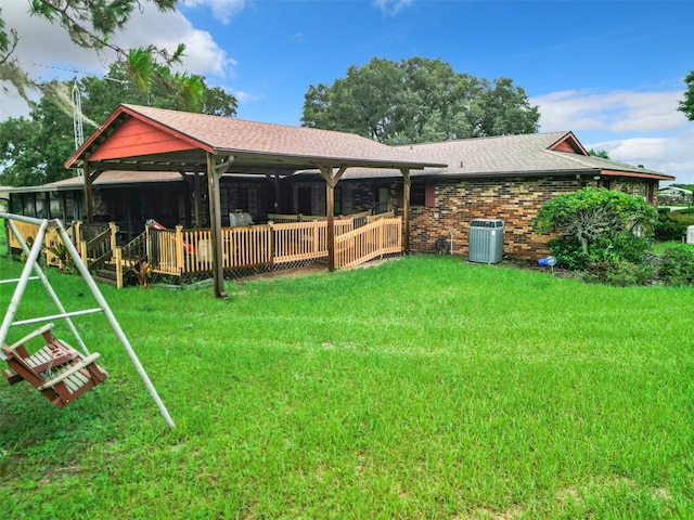 view of yard with central AC and a wooden deck