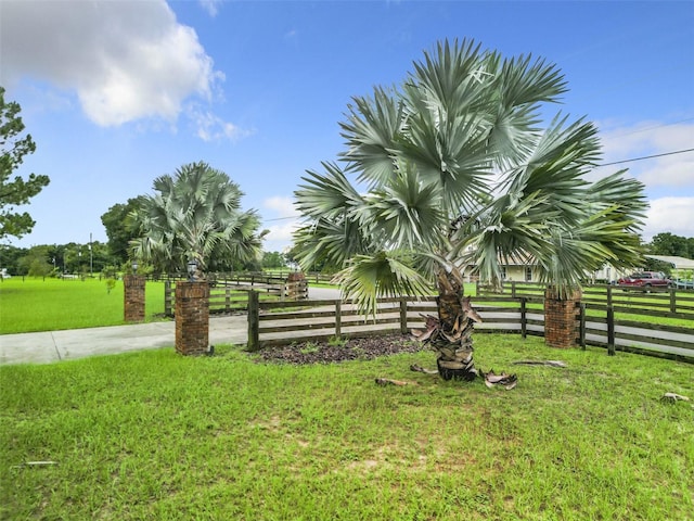 surrounding community featuring a lawn and a rural view