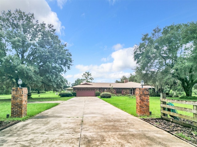 ranch-style house featuring a front yard and a garage