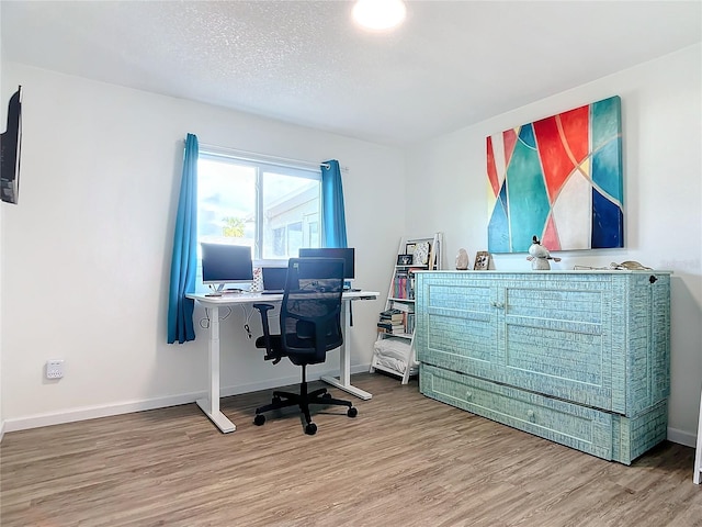 office with a textured ceiling and hardwood / wood-style flooring