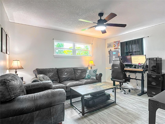 interior space with ceiling fan, hardwood / wood-style flooring, and a textured ceiling