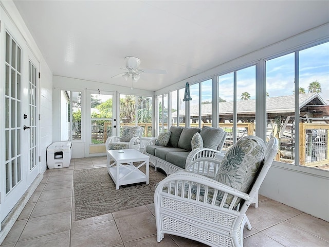 sunroom / solarium featuring a wealth of natural light, ceiling fan, and french doors