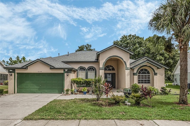 view of front of house with a front yard and a garage