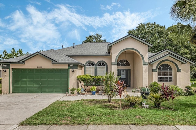 view of front of home with a garage and a front yard