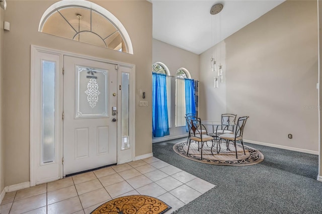 tiled entryway featuring lofted ceiling