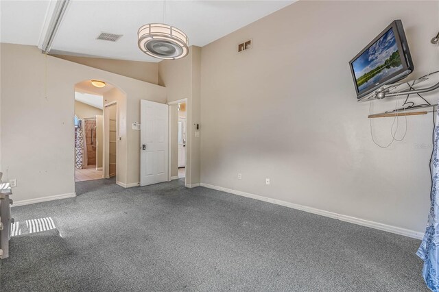 unfurnished bedroom with carpet and vaulted ceiling