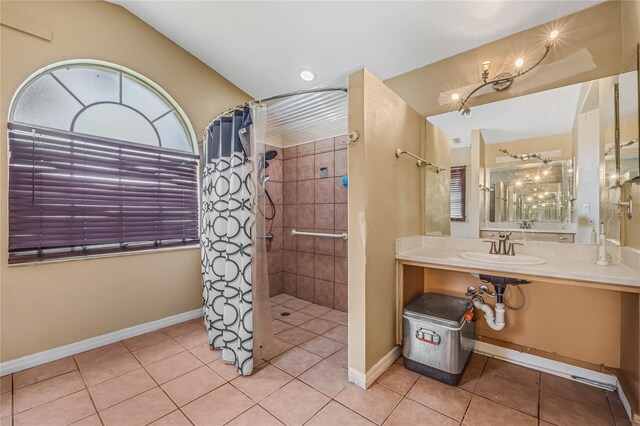 bathroom featuring vaulted ceiling, walk in shower, tile patterned floors, and sink