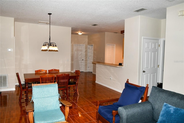 interior space with a textured ceiling and a notable chandelier