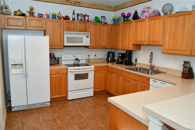 kitchen with white appliances, light tile patterned floors, and sink