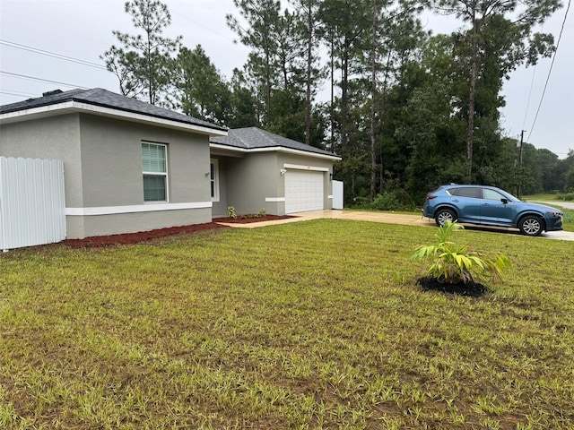 view of front of home featuring a garage and a front lawn