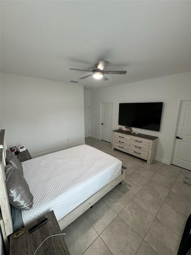 tiled bedroom with ceiling fan