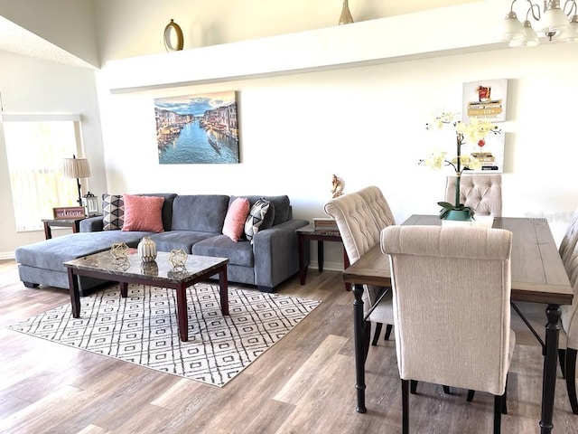 living room with a notable chandelier and wood-type flooring