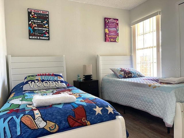 bedroom featuring hardwood / wood-style floors and a textured ceiling