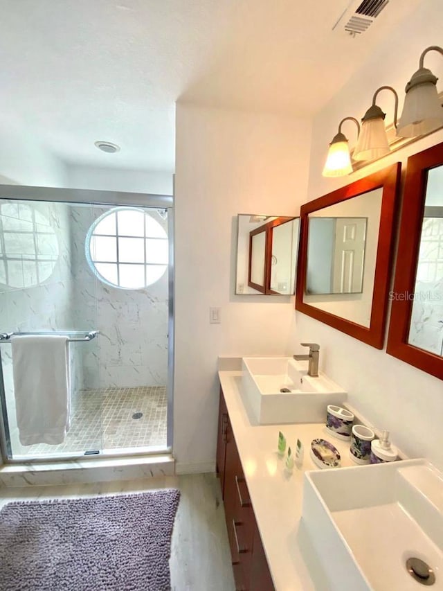 bathroom with vanity, wood-type flooring, and an enclosed shower