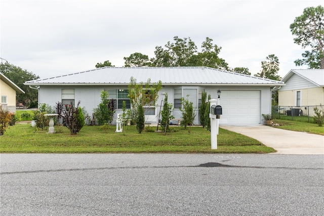 ranch-style home with a front yard and a garage