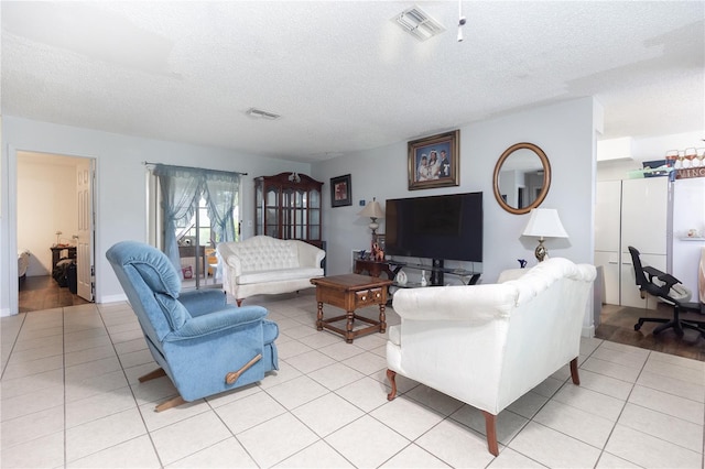 living room with light hardwood / wood-style floors and a textured ceiling