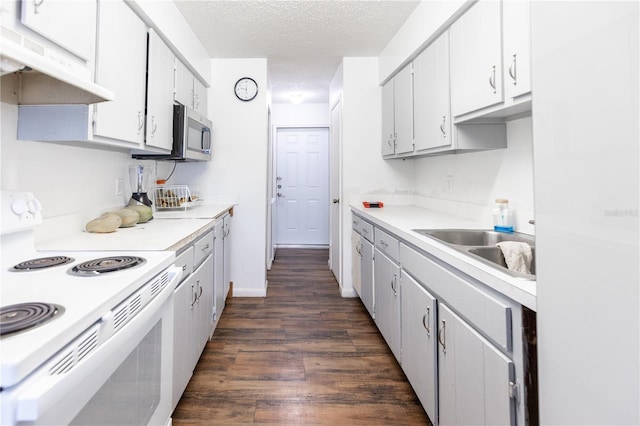 kitchen with dark hardwood / wood-style floors, a textured ceiling, white cabinetry, and white electric range oven