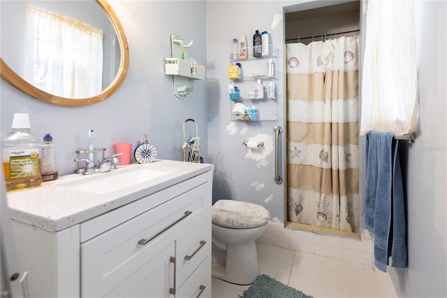 bathroom featuring walk in shower, vanity, toilet, and tile patterned floors