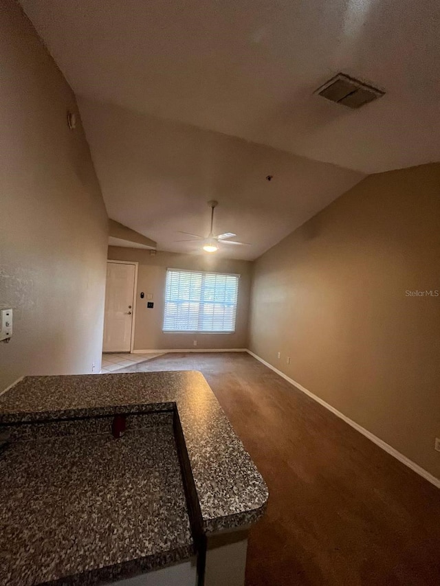 interior space featuring vaulted ceiling and carpet