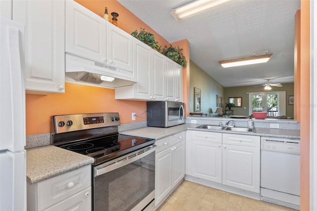 kitchen featuring appliances with stainless steel finishes, white cabinetry, sink, and ceiling fan