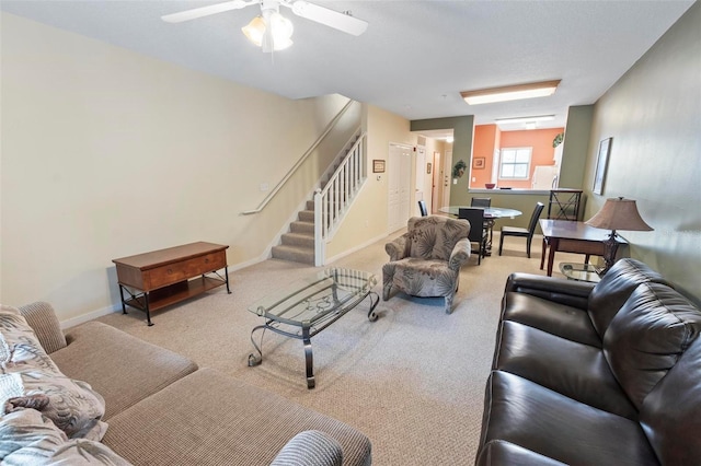 carpeted living room with ceiling fan