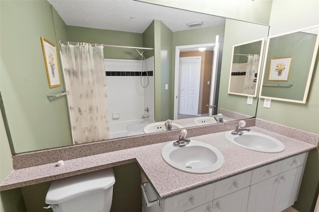 full bathroom with shower / bath combo, a textured ceiling, vanity, and toilet