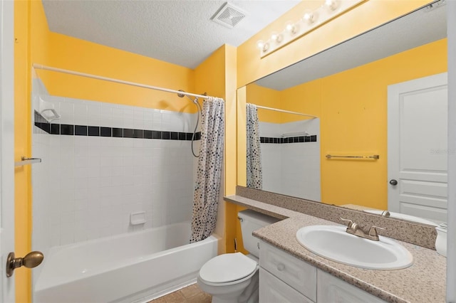 full bathroom with vanity, a textured ceiling, shower / tub combo, tile patterned floors, and toilet