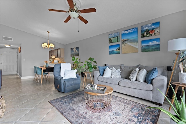 tiled living room with ceiling fan with notable chandelier and vaulted ceiling