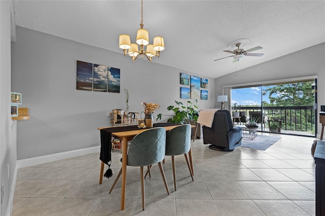 tiled dining area featuring ceiling fan with notable chandelier, lofted ceiling, and a textured ceiling